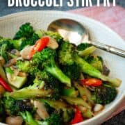 A plate of broccoli salted fish stir fry with text overlay "my go to broccoli stir fry"
