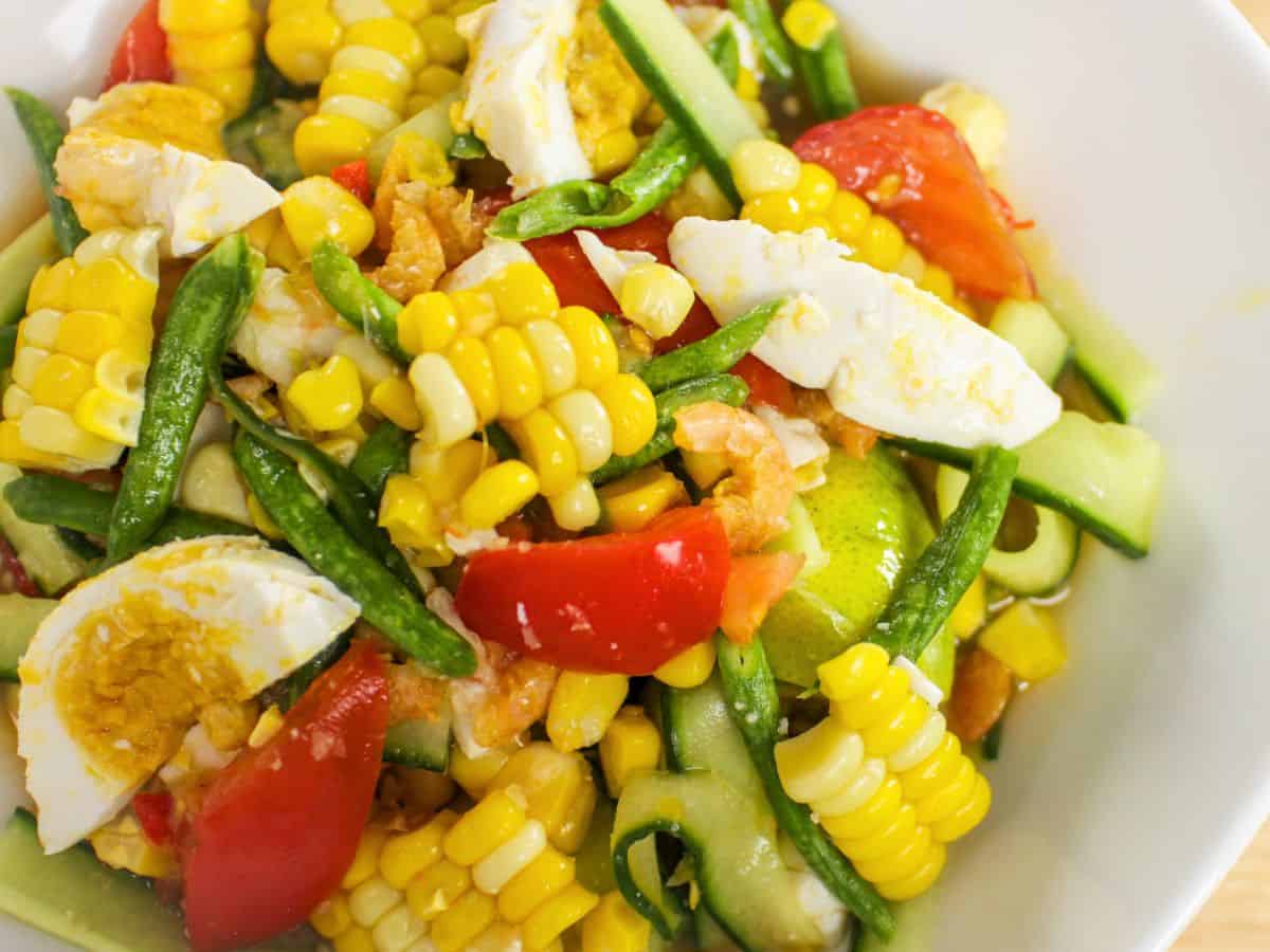 a plate of corn and cucumber salad