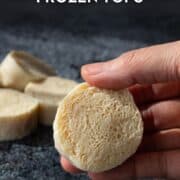 a piece of frozen silken tofu held in hand with text overlay "how to cook with frozen tofu"
