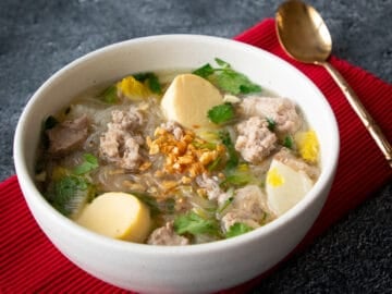 A bowl of thai glass noodle soup with egg tofu