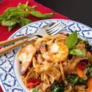 A plate o drunken noodles with shrimp with text overlay "pad kee mao drunken noodles"