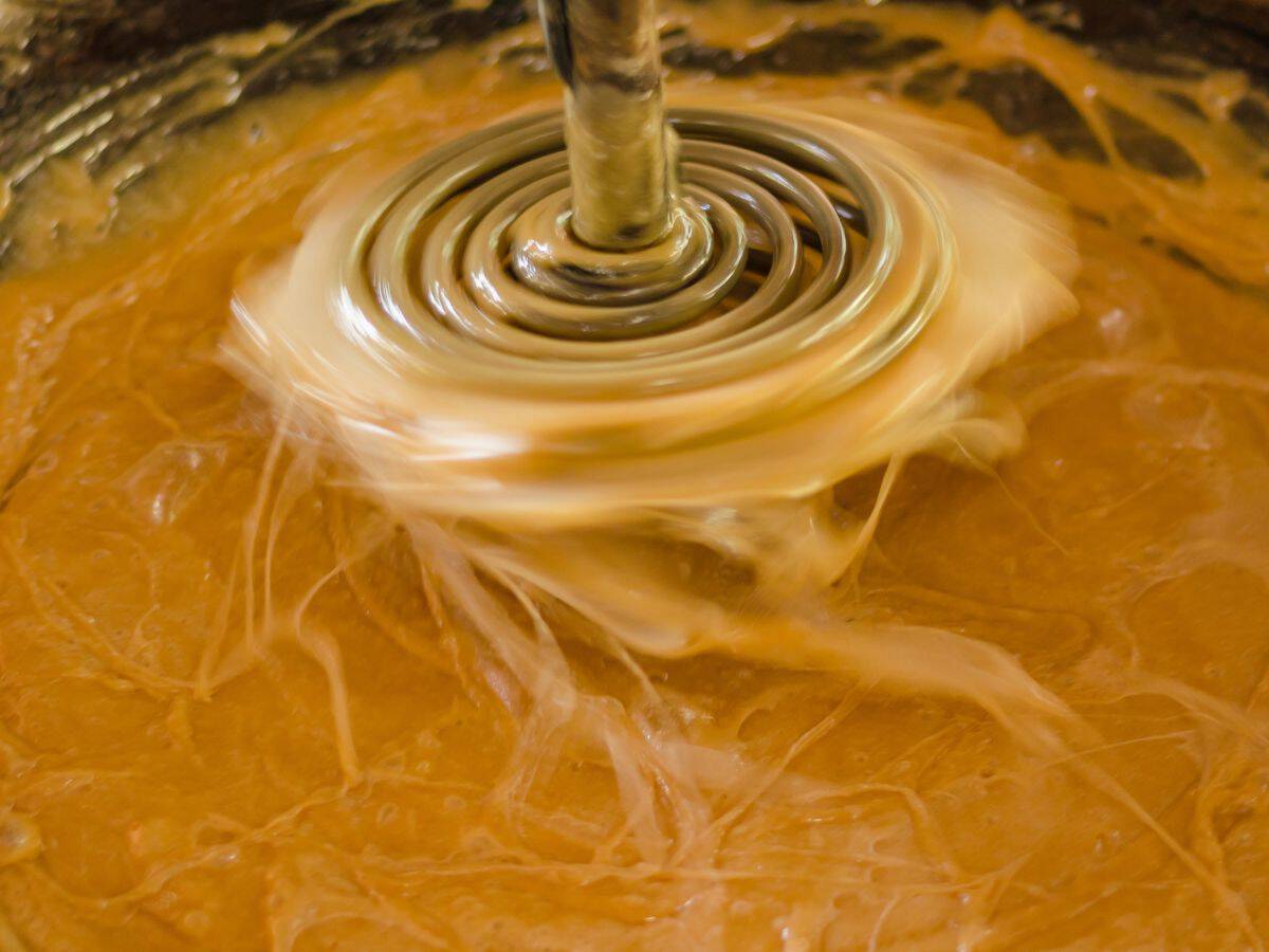 palm sugar being whipped with a whisk