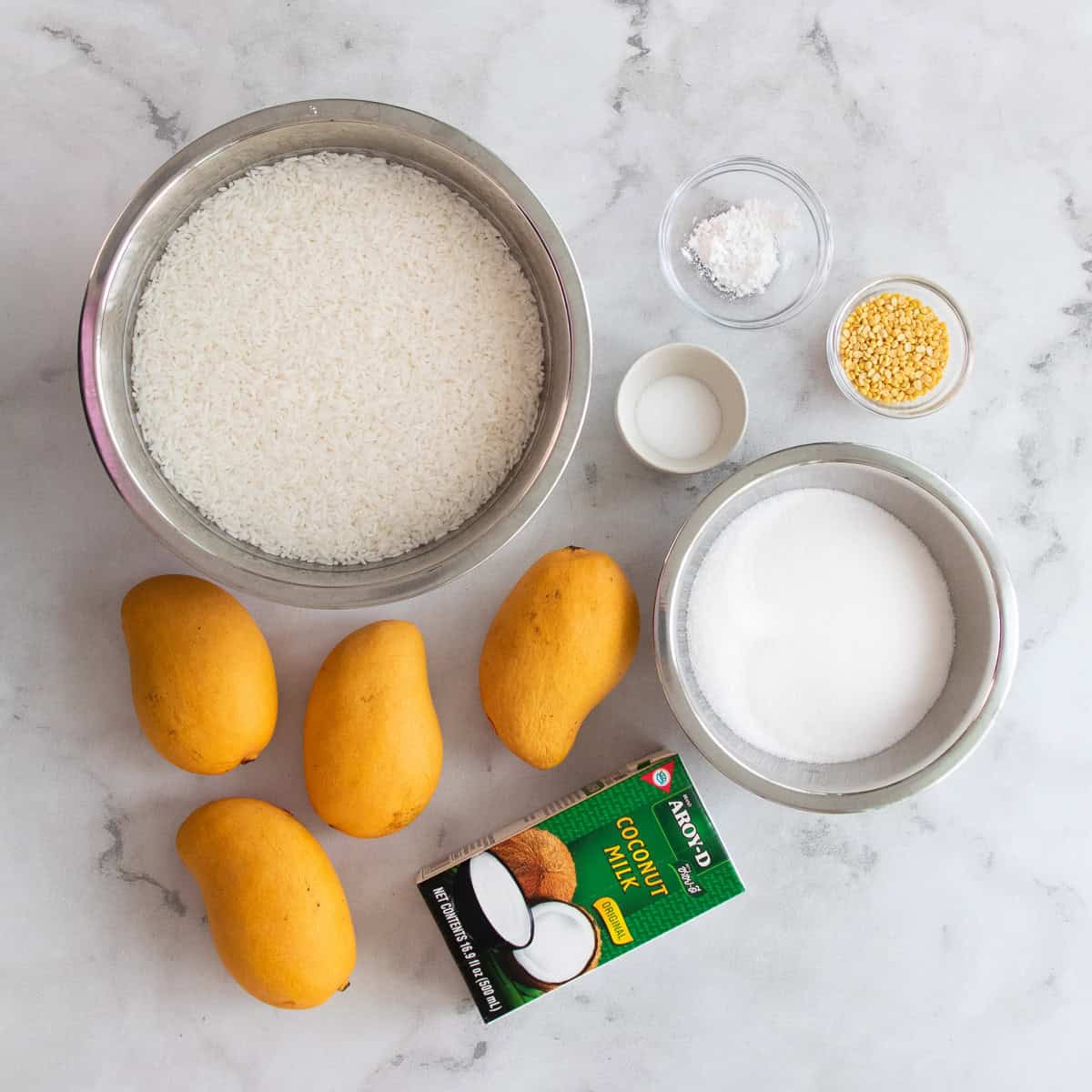 ingredients for mango sticky rice on a table.