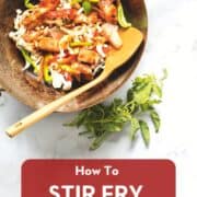 A wok with salmon and vegetables and a spatula with holy basil on the side with text overlay "how to stir fry anything"
