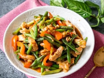 a bowl of green beans and chicken stir fry