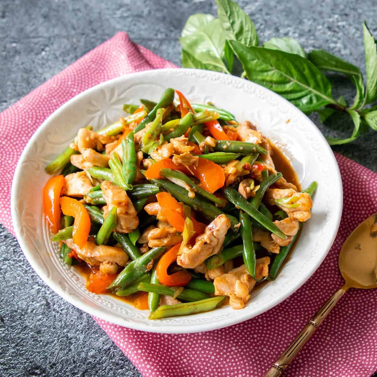 a bowl of green beans and chicken stir fry