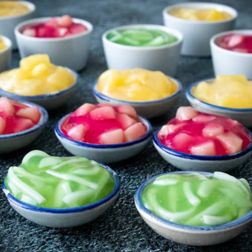 several cups of tako pudding in green, red and yellow
