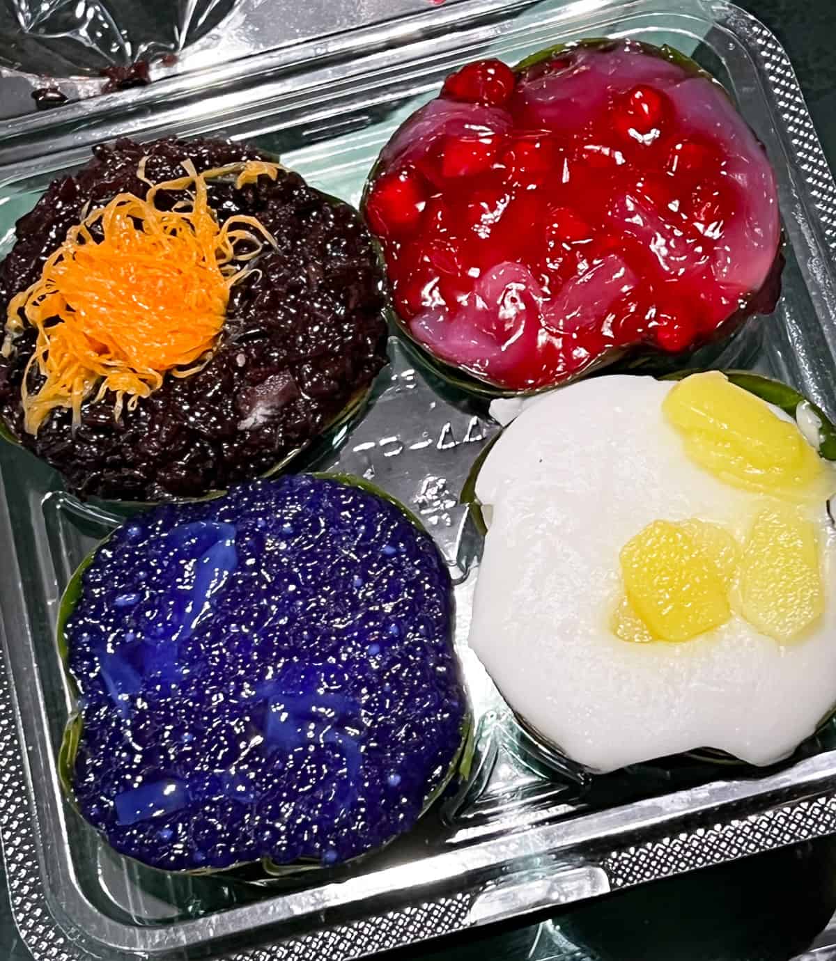 four types of tako: water chestnuts, tapioca pudding, black sticky rice pudding, and white coconut with water chestnuts garnish