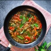 Thai basil sauce in a skillet with text overlay "all-purpose Thai basil sauce"