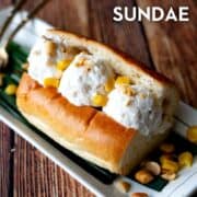 Coconut ice cream in a hot dog bun topped with peanuts and corn, with text overlay "THai coconut Ice Cream Sundae" and "hotthaikitchen.com"